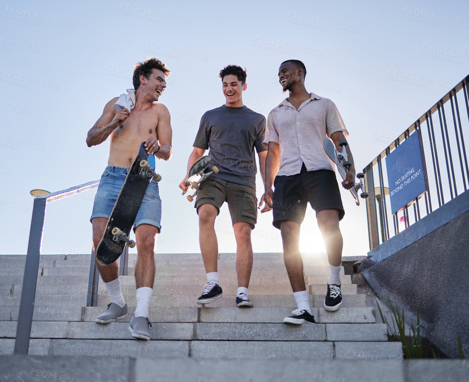 Buy stock photo friends, walking with skateboard together in city outdoors for fun, laugh and conversation support. Diversity, young gen z men talking and sport fitness lifestyle or urban trendy street fashion