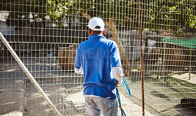 Buy stock photo Volunteer, charity and animal shelter with a black man working at a rescue center for the adoption of foster pets. Worker, community and care with a male employee at work alone with rescue animals