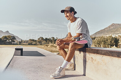 Buy stock photo Skateboard, fitness and recreation with a sports man sitting on a wall at a skatepark during the day. Exercise, training and skating with a male athlete or skater having fun outdoor in summer