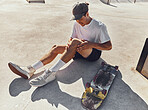 Skateboard, knee and injury with a sports man holding his leg joint in pain after a fall or accident outdoor. Fitness, skatepark and exercise with a male athlete suffering in agony while skating