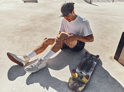 Buy stock photo Skateboard, knee and injury with a sports man holding his leg joint in pain after a fall or accident outdoor. Fitness, skatepark and exercise with a male athlete suffering in agony while skating
