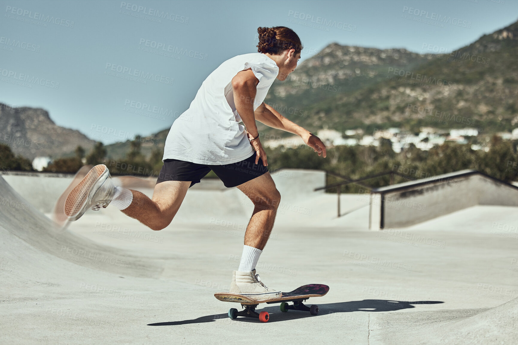 Buy stock photo Skating, young man and skateboard at skate park in urban city, fitness or training for trendy hobby. Youth, skater and physical activity in concrete cityscape, skateboarder and sport exercise outdoor