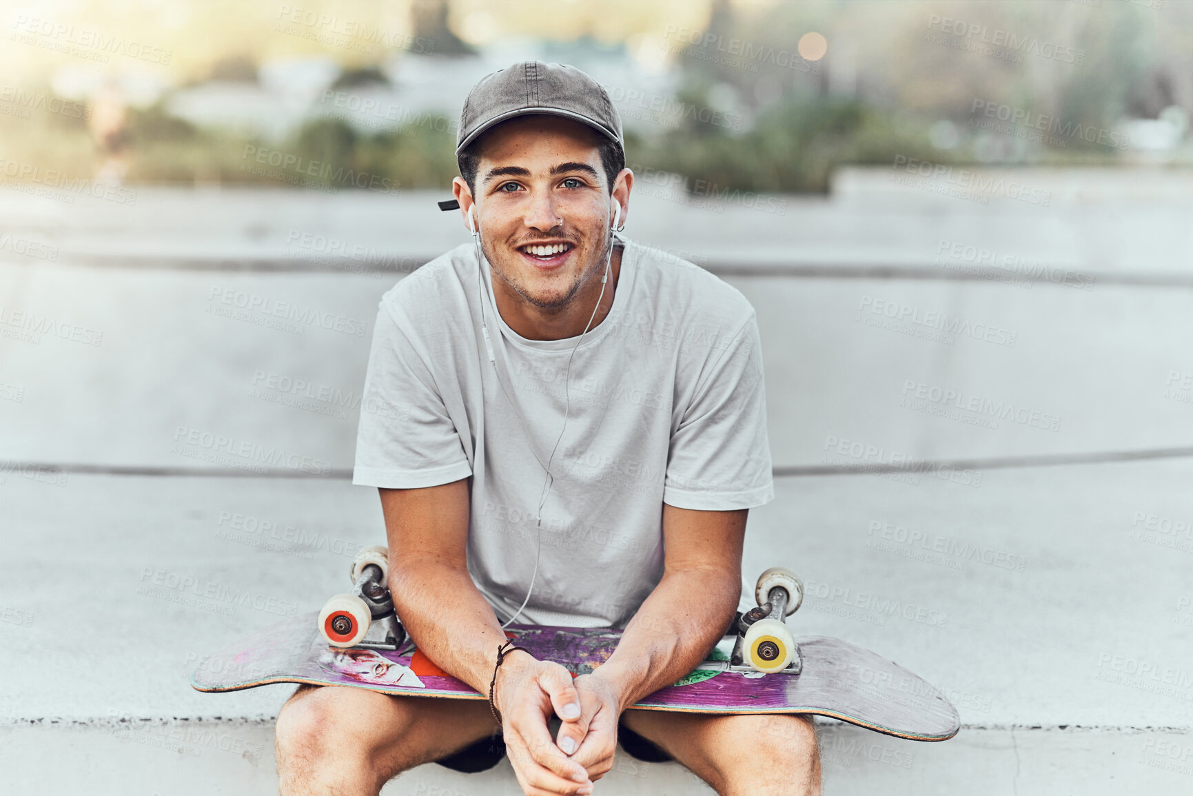 Buy stock photo Young man, skateboard and skater with music at urban skate park, youth and recreation with earphones for audio streaming. Happy, portrait, and gen z outdoor with skating practice and fitness.
