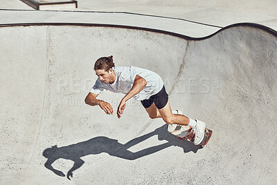 Buy stock photo Skateboard, ramp and man skating at a park for exercise or practice at an urban city in Canada. Fitness, adventure and athlete skater doing skateboarding trick while training for a sports competition