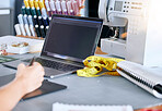 Fashion, designer and laptop for a sketch or drawing for clothes manufacturing in a tailor workshop or factory for creative ideas. Hand of woman at desk with design technology for illustration work