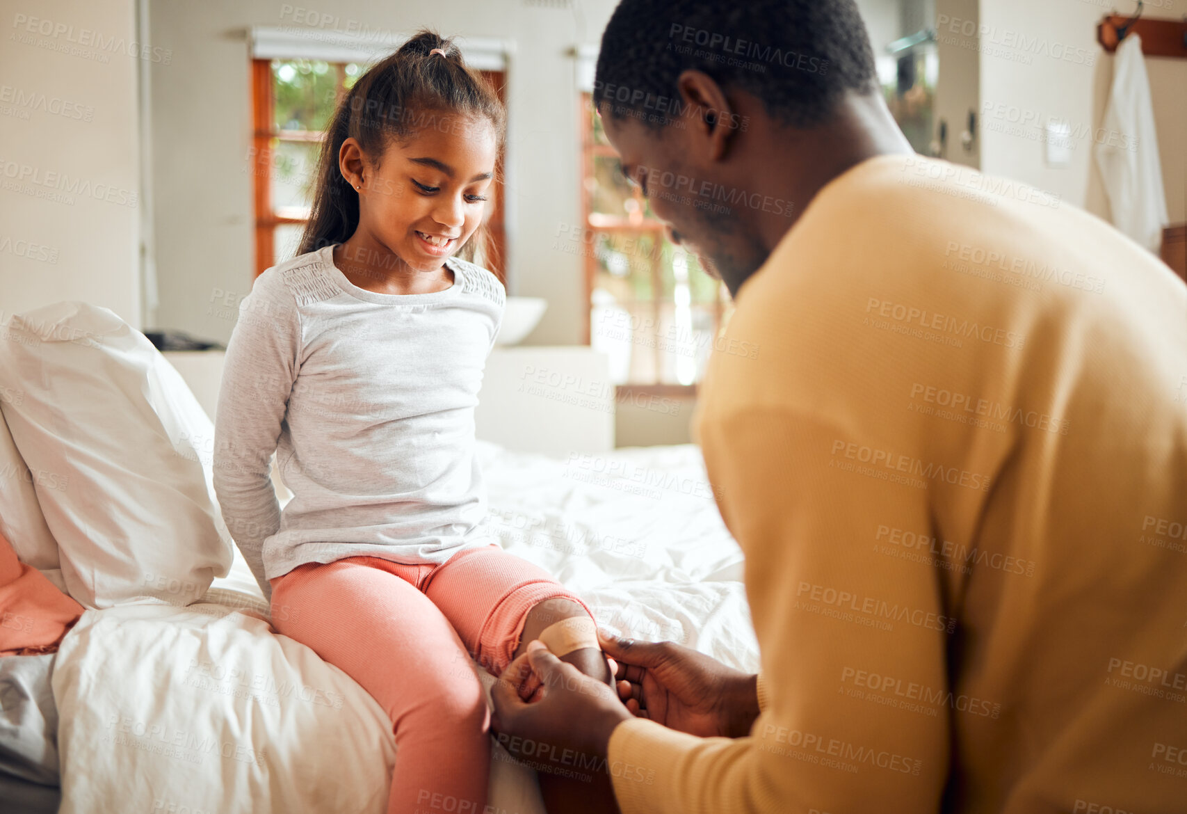 Buy stock photo Black family, father and knee bandage for girl after accident or injury. First aid, healthcare and man apply plaster on leg of hurt or injured child for wellness and recovery in bedroom.