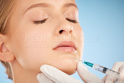 Buy stock photo Woman, studio and injection for lip filler, beauty and anti aging skincare process by blue background. Model, facial plastic surgery and syringe needle with doctor, surgeon or cosmetic expert