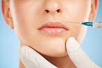 Change, facial and lip filler by woman with cosmetic injection isolated against a studio blue background. Beauty and closeup of girl get plastic surgery at a cosmetology clinic using a syringe