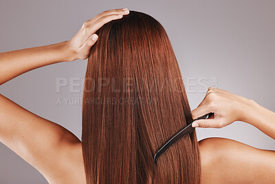 Buy stock photo Beauty, comb and woman doing haircare in a studio with a keratin treatment. Health, hygiene and back of female model with a long, healthy and shiny hair style by a gray background