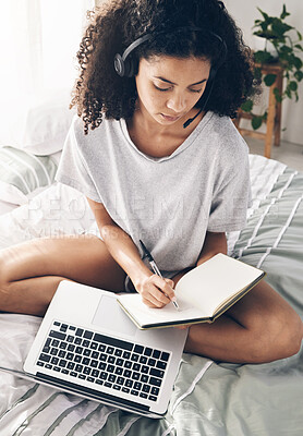 Buy stock photo Book, writing and black woman with laptop and headphones for studying or online learning. Scholarship, student and female with headset, computer and notebook in virtual class on bed in bedroom home.