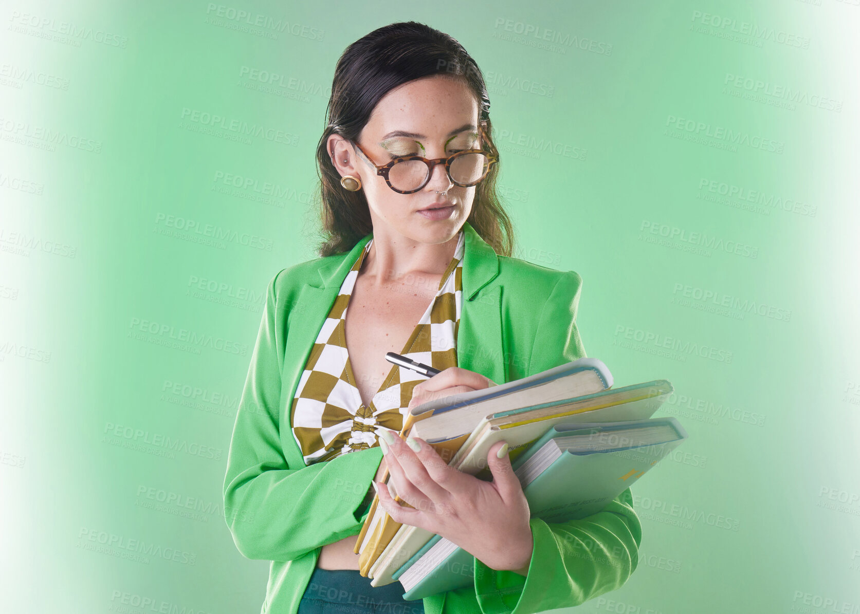 Buy stock photo Education, teacher and a woman writing on books isolated on green background in a studio. Professor or student fashion gen z person with glasses and notebook for learning and studying on backdrop