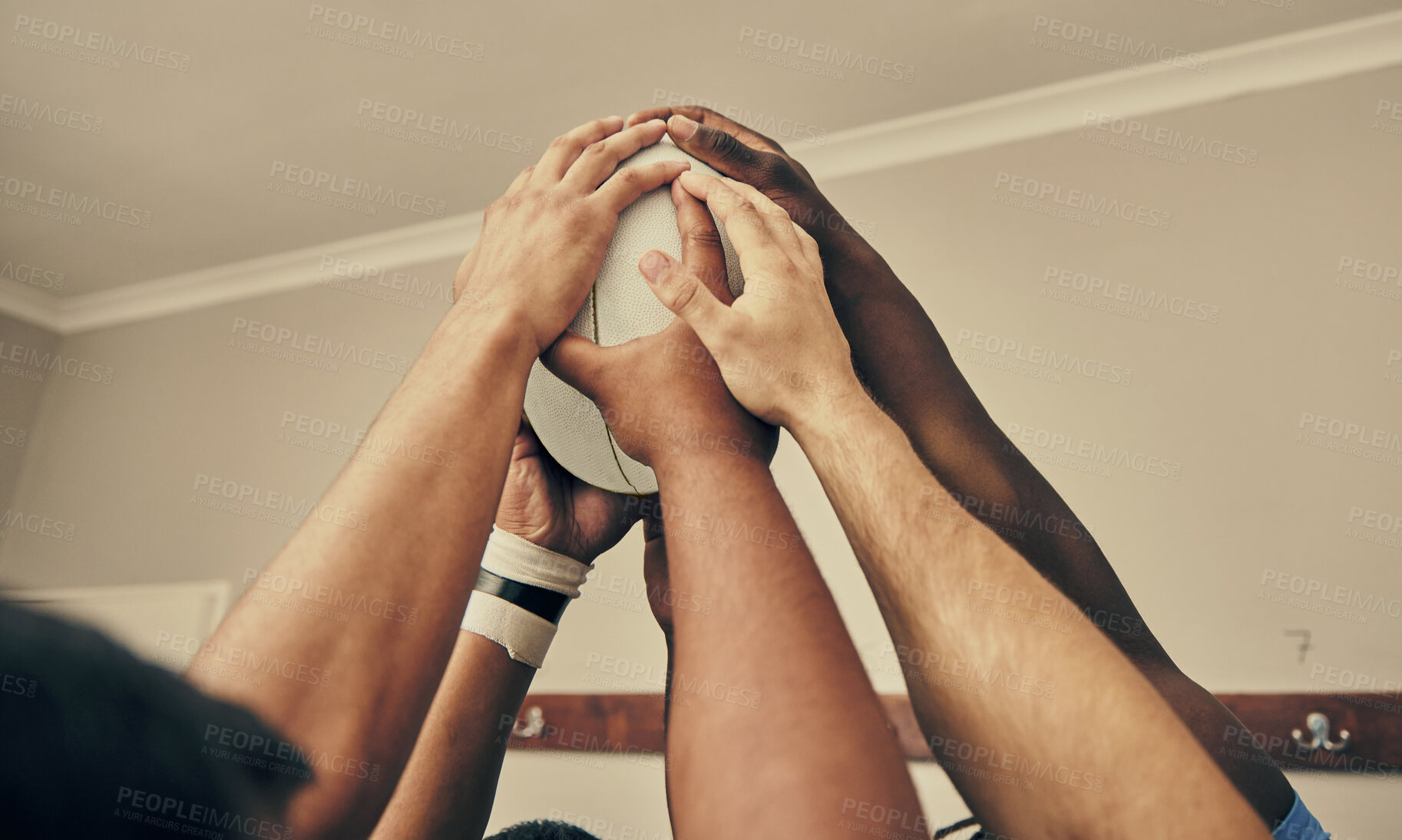 Buy stock photo Locker room, hands together and rugby team huddle with with ball, motivation and teamwork before game. Training, coaching and group of motivated sports players with commitment, dedication and support