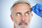 Face closeup and senior man in a studio looking at plastic surgery doctor doing cosmetic skincare. Dermatology, wrinkles and anti aging treatment of a model with silicone filler injection