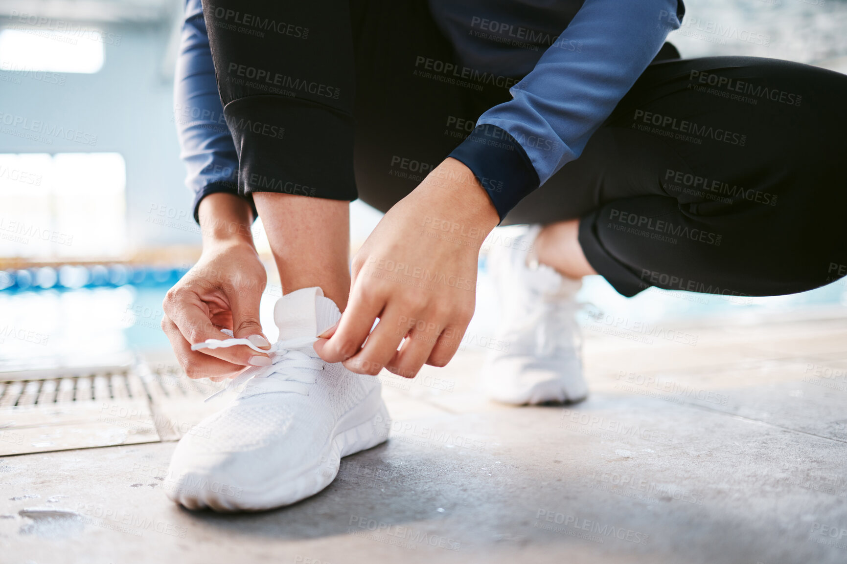 Buy stock photo Tie shoes, hands and fitness at swimming pool to start workout, exercise or training. Sports, athlete and woman tying sneakers to get ready for swim, practice or exercising for health and wellness.