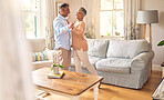 Love, retirement and dance with a senior couple in the living room of their home together for bonding. Marriage, romance or bonding with an elderly man and woman dancing in the lounge of their house