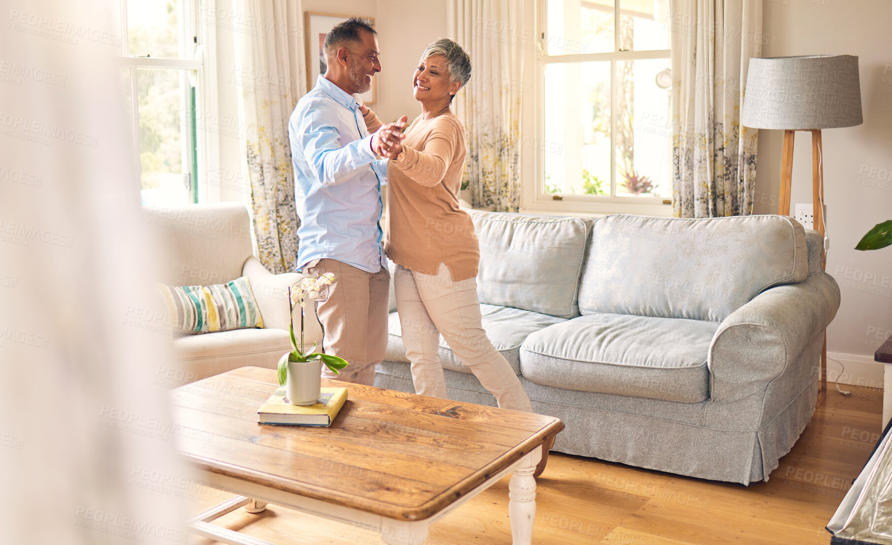 Buy stock photo Love, retirement and dance with a senior couple in the living room of their home together for bonding. Marriage, romance or bonding with an elderly man and woman dancing in the lounge of their house