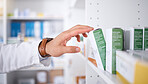 Pharmacist hand, shelf and boxes with choice, packing stock and inventory inspection in shop. Pharmacy manager, package and product label for healthcare, pills and health with drugs in retail store