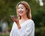 Audio phone call, happy and a woman in nature for communication, chat or voice instruction. Smile, park and an Asian girl speaking on a mobile for networking, audio recording or conversation