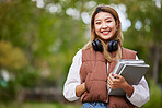 Student with headphones, portrait and woman with books for learning, education and on university campus with happiness or pride. Happy, face and girl in college with notebook or walking to class