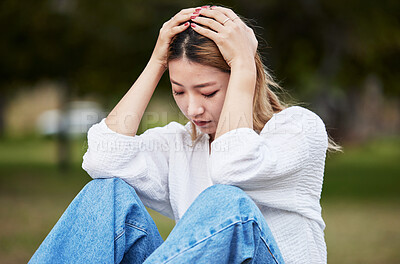 Buy stock photo Sad, depression and a woman in a park with a mental health problem, thinking and anxiety. Tired, idea and a girl or person in a garden or field with fear, anger or depressed about a mistake or fail