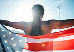 Athlete, American flag and sports with a woman outdoor at a stadium to celebrate country, pride and win. Back of a person for sport event, fitness and exercise achievement at competition in USA