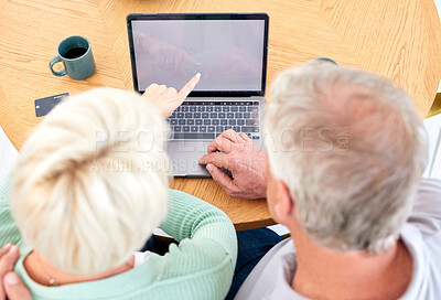 Buy stock photo Laptop, top view and senior couple at table for online shopping, reading email and point at mockup space on screen. Computer, above and elderly people on desk for payment, search or banking in home