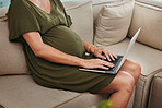 Woman, pregnant and typing with laptop on sofa in office for business, research or email. Female person, mother and employee with technology for website, digital marketing and online consultation