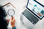 Magnifying glass, laptop and woman reading document in the office for company recruitment website. Research, technology and closeup of female designer with hiring paperwork and computer in workplace.