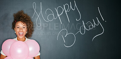 Buy stock photo Woman, balloons and studio with happy birthday in chalk, words or text with celebration isolated on blackboard background. Mockup, smile for special event and African model with sign for party