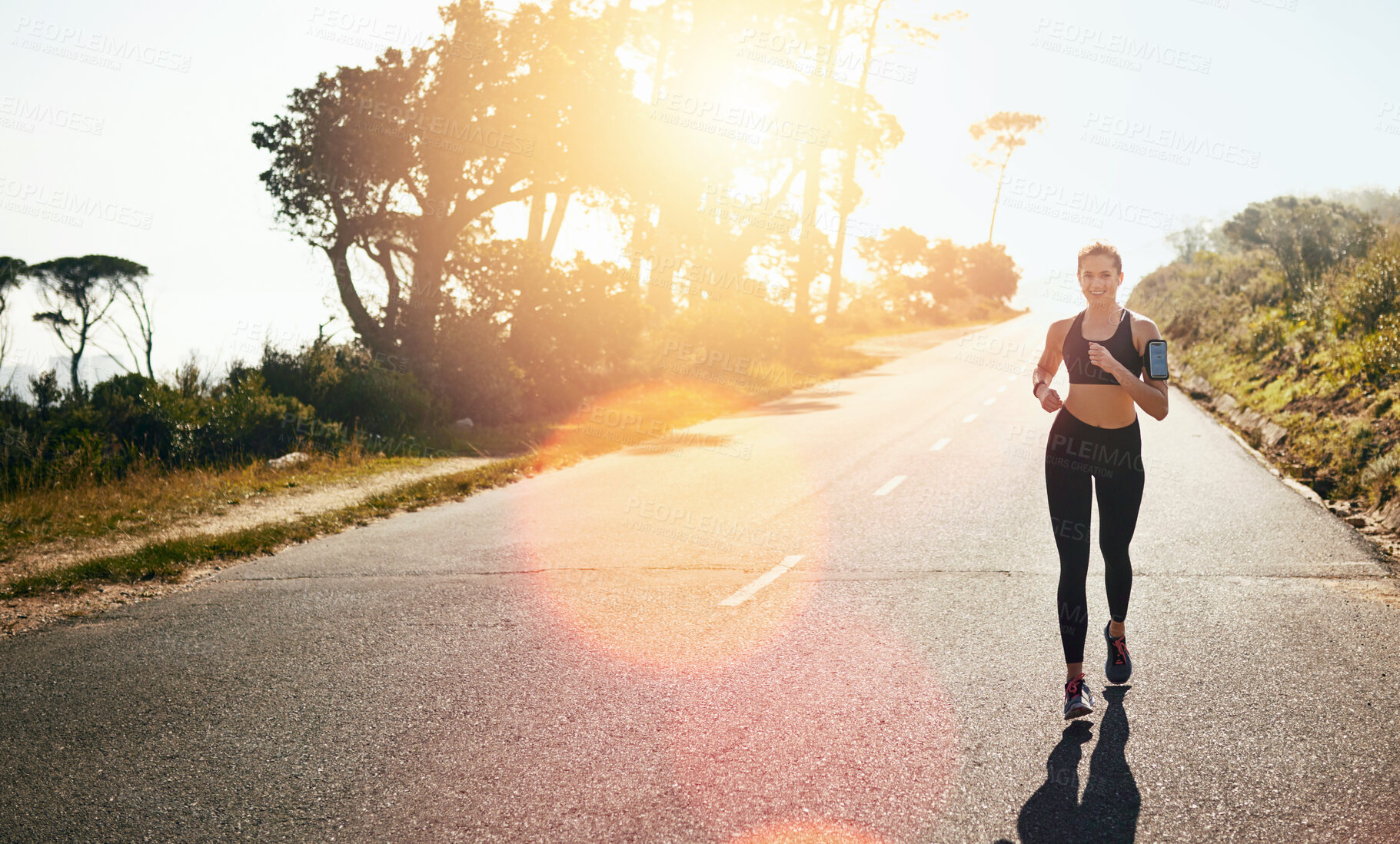 Buy stock photo Running, woman and fitness for outdoor training, cardio workout or endurance challenge. Lens flare, wellness and female athlete person in road for exercise, marathon or performance in California