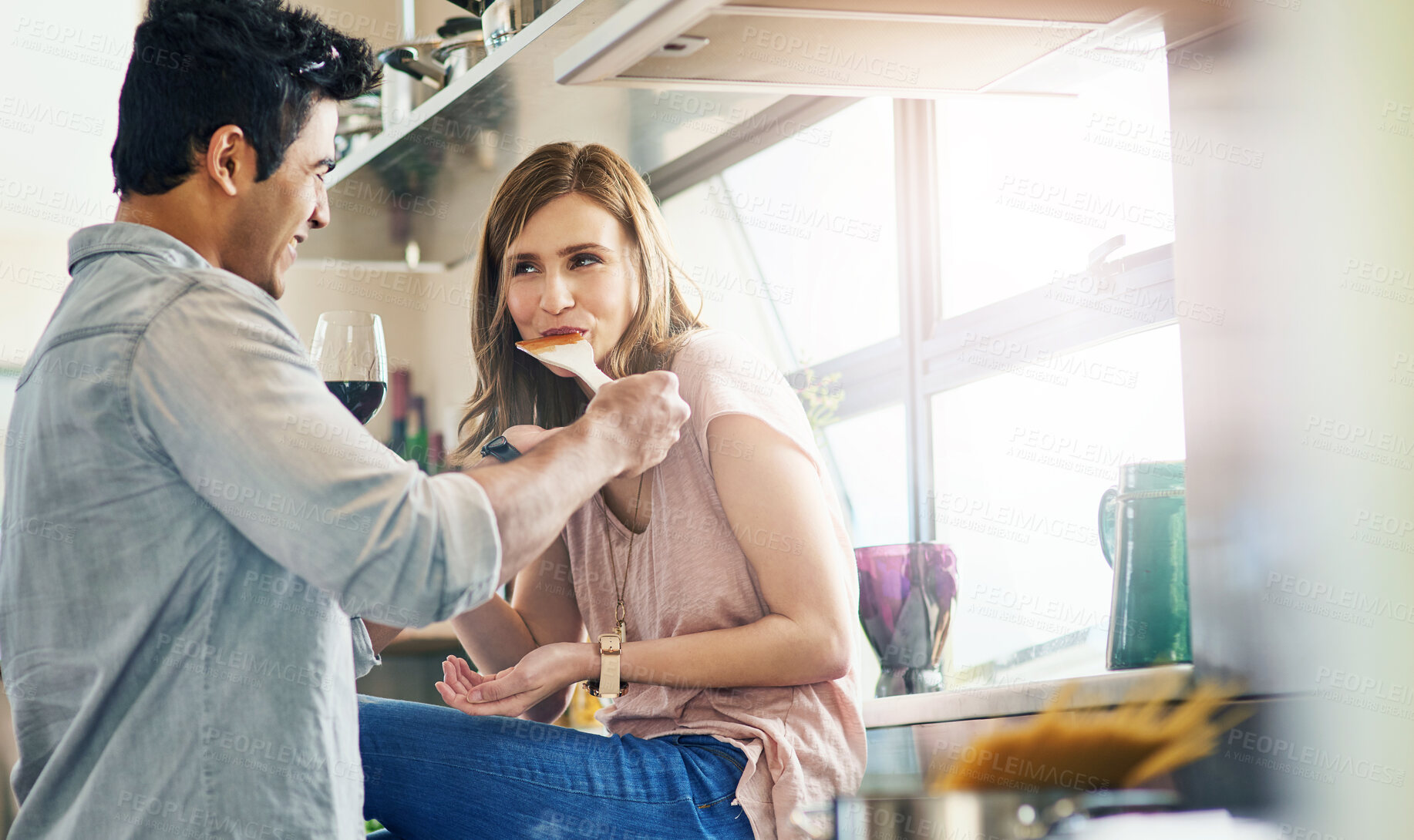 Buy stock photo Man, woman and taste for cooking, together and eating with relationship and love in kitchen. Couple, home and food for play, diner or supper with romance and recipe for date and relaxation in house