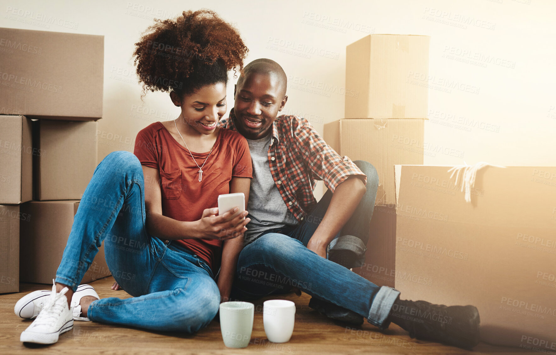 Buy stock photo Couple, moving and relax in home with phone to search property, app and reading mortgage info. Happy, people and scroll online shopping website for house furniture, package or application for rent