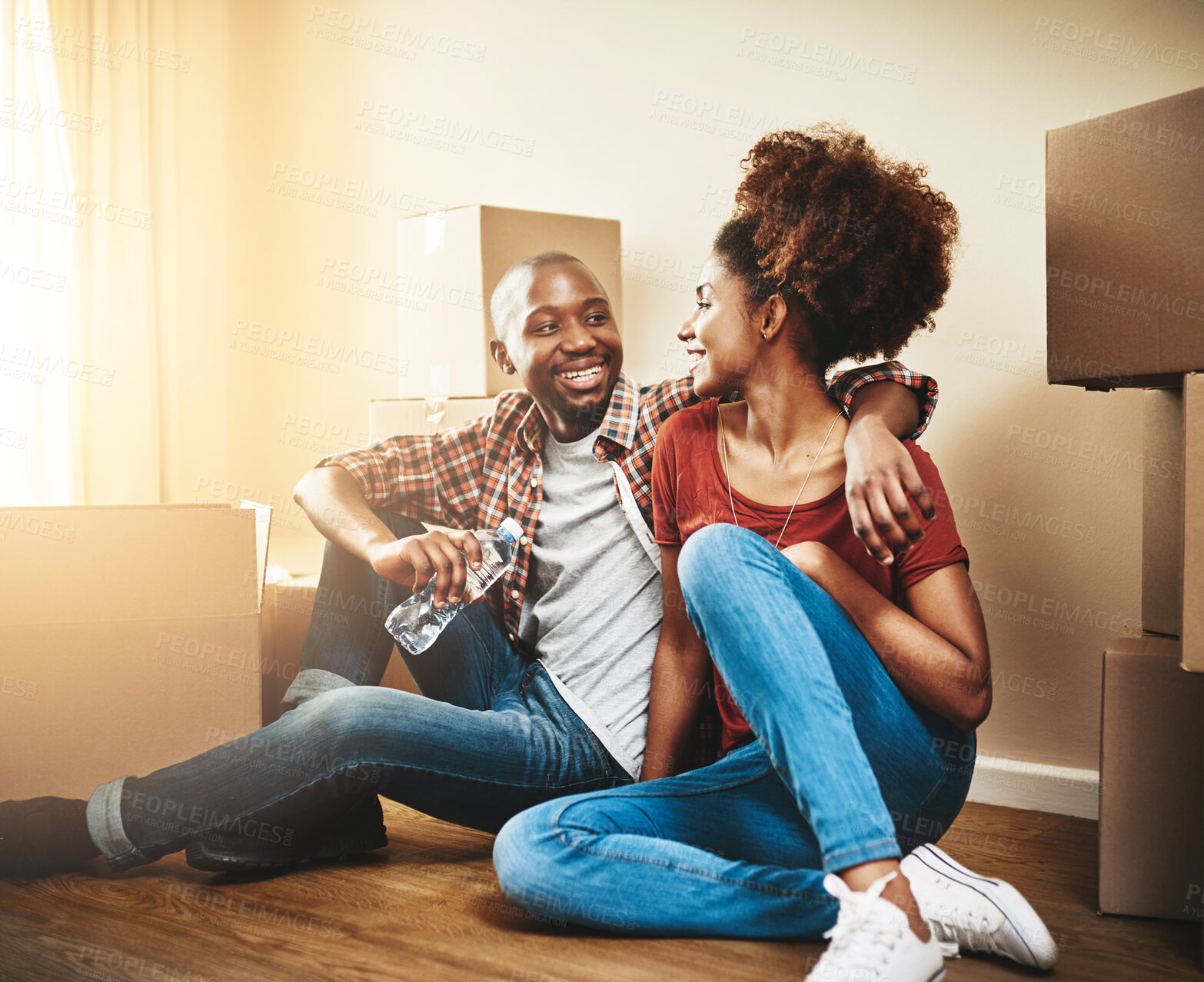 Buy stock photo Happy, couple and box in new house on floor with property investment, security and safety in mortgage. Man, woman and smile with hug in purchase of real estate for homeowner, marriage and relocation