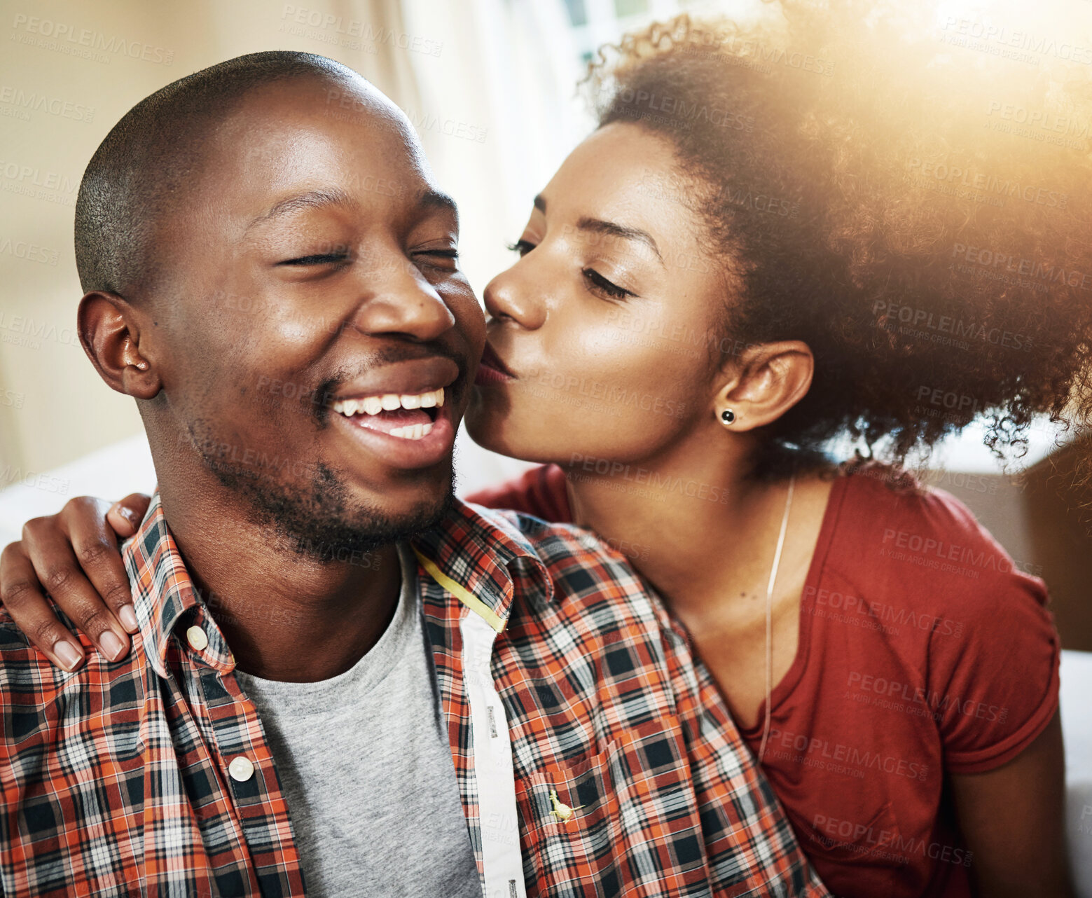 Buy stock photo Kiss, love and black couple on sofa in new home with affection, marriage and mortgage. Smile, happy man and woman on couch with romantic embrace, property investment and excited together in house.