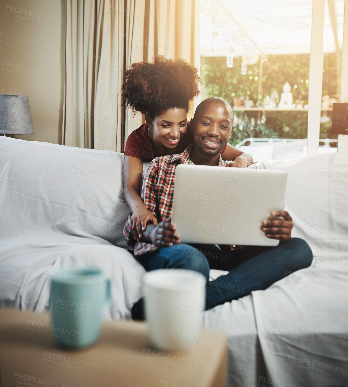 Buy stock photo Home, smile and black couple with laptop, love and connection with internet, relaxing and lens flare. Apartment, sunshine and man with woman, computer and online reading with video and relationship