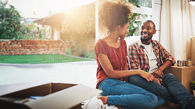 Buy stock photo Black couple, real estate and happy on floor of new house with bonding, support and break or relax from moving. People, homeowner or smile for property investment, dream home or relocation with boxes