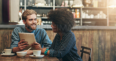 Buy stock photo Couple, tablet and happy on date in cafe with social media streaming, bonding and online information. Interracial, people and smile in coffee shop with tech app for post update, discussion and relax