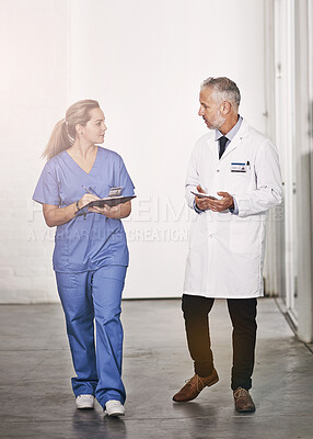 Buy stock photo Doctor, man and woman with writing for internship, advice and teaching in hospital hallway. People, mature medic and mentorship for healthcare service with checklist, notes and information in clinic