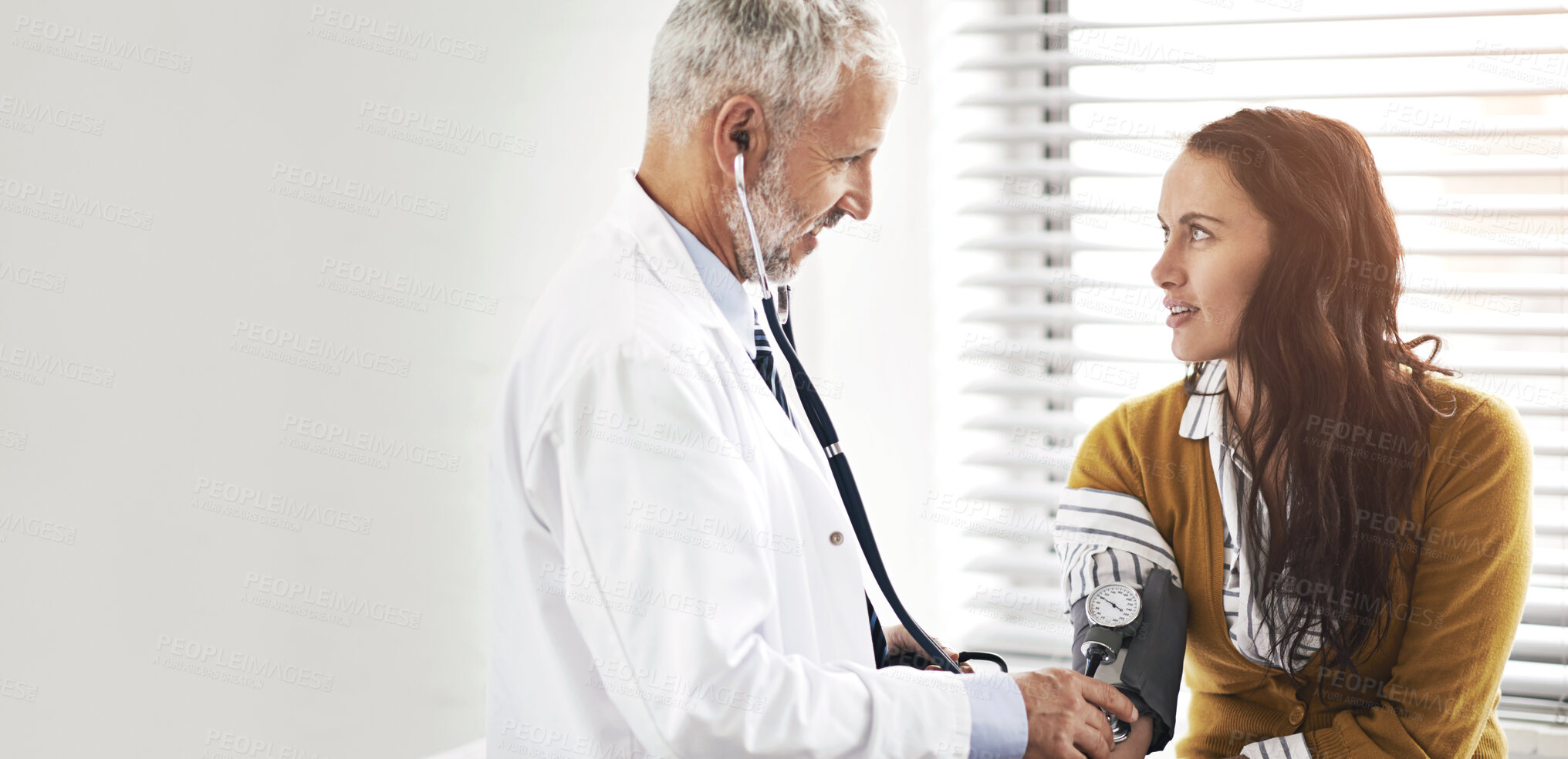 Buy stock photo Doctor, blood pressure and woman with conversation at hospital with consultation for health insurance. Healthcare, stethoscope and check pulse for medical exam, wellness and hypertension diagnosis