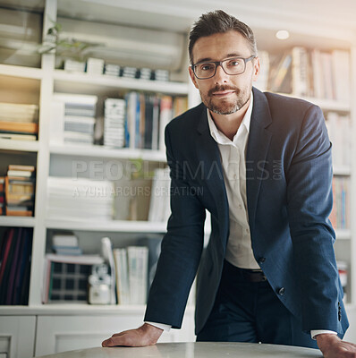 Buy stock photo Portrait, businessman and leaning on desk in office for corporate job with pride, mission and glasses. Workplace, table and serious male lawyer with professional career for consulting and confidence