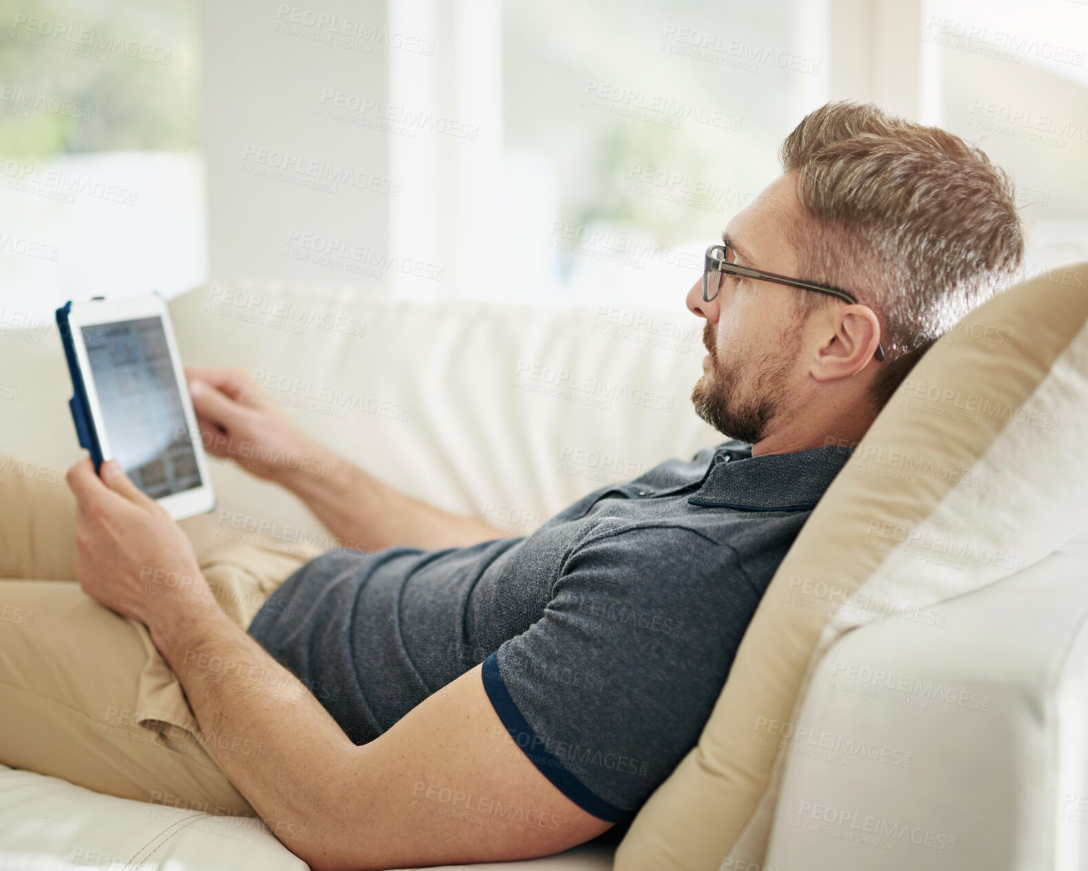 Buy stock photo Digital, screen and man relax on a sofa with social media, search or internet, scroll and streaming subscription at home. Tablet, ecommerce and living room with online shopping, app or menu choice