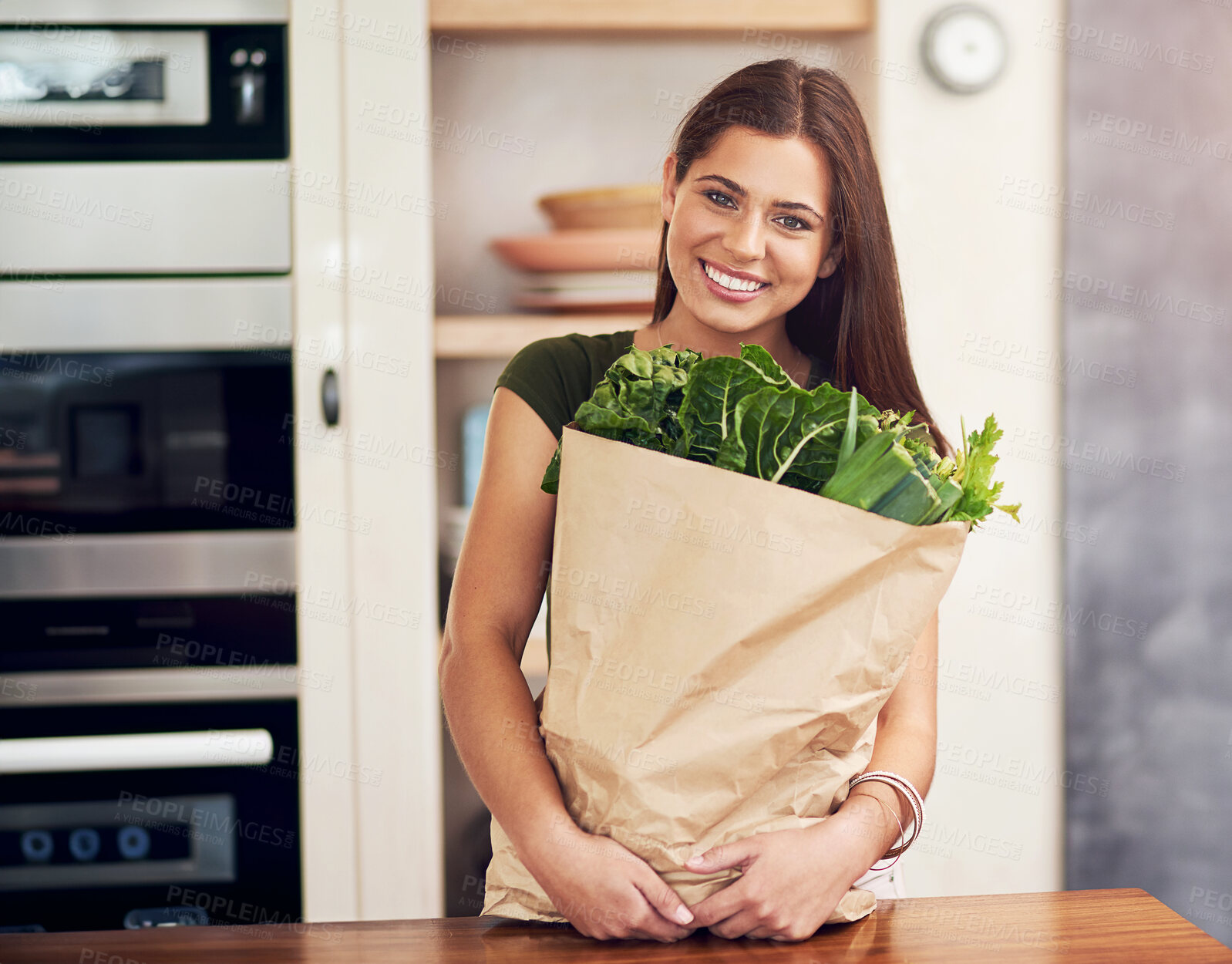 Buy stock photo Woman, portrait and bag with vegetables in kitchen for grocery shopping, healthy food and spinach. Person, face and happy with cooking ingredients for nutrition, organic meal or fresh produce in home