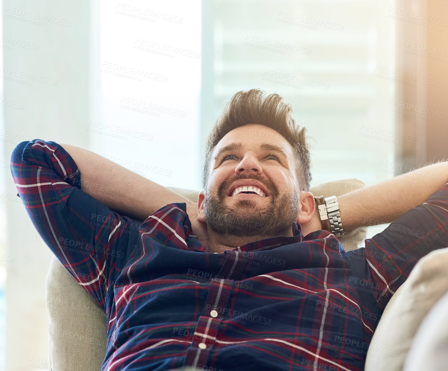 Buy stock photo Happy, man and stretching on sofa to relax, rest and energise at home on weekend or vacation. Male person, smile and hands behind head on couch for comfort and wellness on day off or holiday