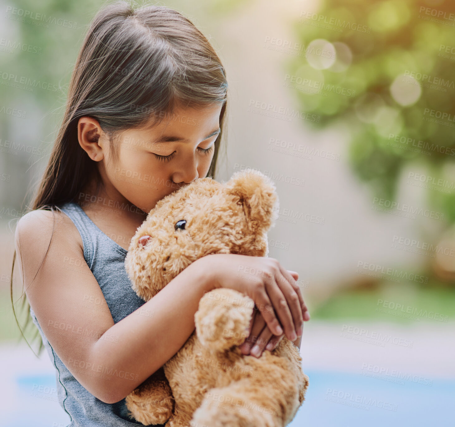 Buy stock photo Happy, outdoor and girl with teddy bear, kissing and comfortable with happiness at home garden. Toddler, child development and love with fluffy toy gift outside for hugging, cozy and comfort