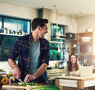 Buy stock photo Couple, man cooking and conversation with woman, vegetables and happiness with love, ingredients and smile. People, apartment and wellness with healthy meal, nutrition and wine with break and dinner