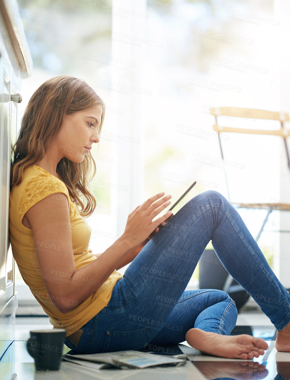Buy stock photo Woman, tablet and relax on kitchen floor for typing, coffee or planning on app for schedule. Girl, writer and author with thinking for creativity, notes or inspiration for story development in house