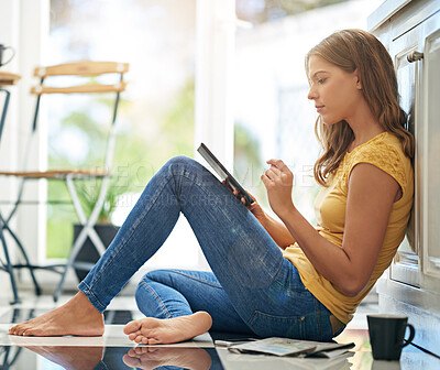 Buy stock photo Woman, tablet and reading on kitchen floor with typing, coffee and planning with app for schedule. Girl, writer and thinking for creativity, notes and inspiration for story development in morning