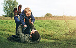 Dad, child and playing together in nature with happy laugh, grass and bonding in outdoor garden. Father, son and playful games in backyard for growth, development and fun with energy, smile and care.