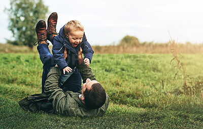 Buy stock photo Dad, child and playing together in nature with happy laugh, grass and bonding in outdoor garden. Father, son and playful games in backyard for growth, development and fun with energy, smile and care.