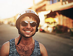 Man, closeup and smile in city with helmet for commute, sunglasses on street for holiday. Male person, happiness and safety for travel in urban with buildings, cheerful on vacation in Costa Rica